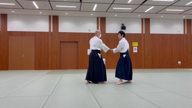 片手持ち呼吸投げ（入身投げ）の稽古を行いました。  この動きは、両手を持たれた場合には天地投げへとつながる理合いを持っています。今回は片手持ちのため、取られた瞬間に自由な手を相手の首筋へ伸ばしながら入身し、手刀を通じてまず相手の中心軸を横方向へ崩します。  この横方向の崩しがあるからこそ、続く手刀と全身の動きによる下方向への崩しが無理なく働き、相手を自然に導くことができます。  一見するとシンプルな技ですが、その中には間合い、体捌き、重心移動、そして崩しの連動が凝縮されています。  #合気道 #Aikido #呼吸投げ  #片手持ち #入身 #崩し #体捌き #間合い #武道 #演武 #稽古 #護身術 #日本武道 #港区